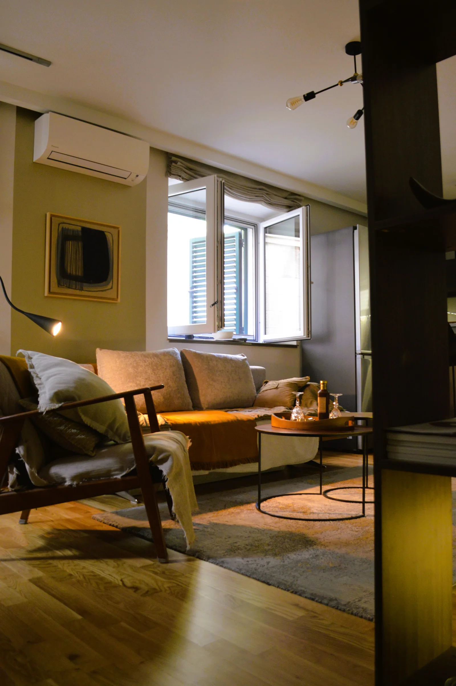 Living room with sofa, brass side tables and oak floor