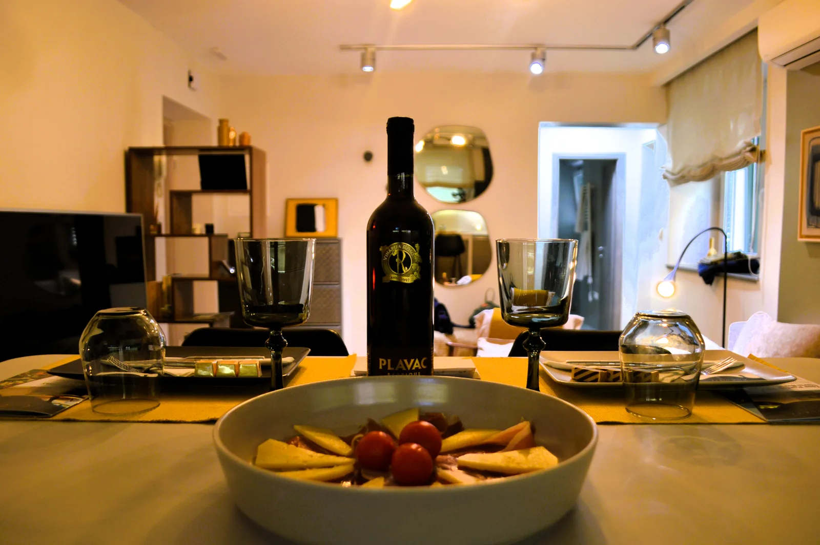 Welcome table set with local wine, cheese and chocolate